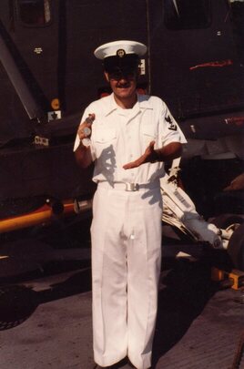 Godfrey manipulating silver dollars in front of the H-2 helicopter that he would fix. To this day people love seeing his amazing coin magic.