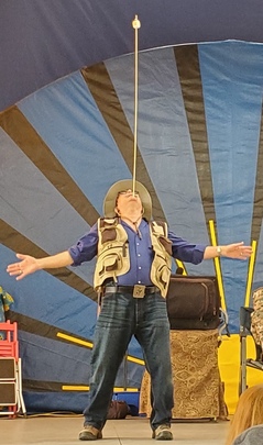 Godfrey balancing a marshmallow on a stick on his chin